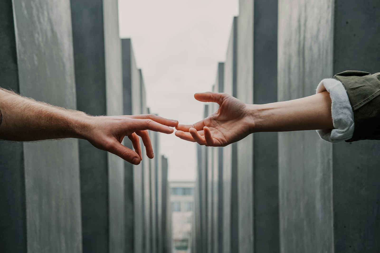 Two hands reaching toward each other, a symbol of mental health support